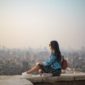 woman-sitting-on-top-of-buildings-edge-150x150